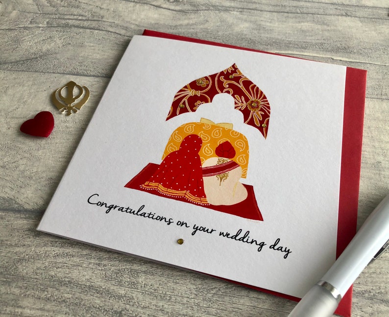Anand Karaj Sikh wedding card. Illustration shows the Sikh couple sitting before the Guru Granth Sahib (Sikh Holy Book) Front is printed with, Congratulations on your wedding day.
