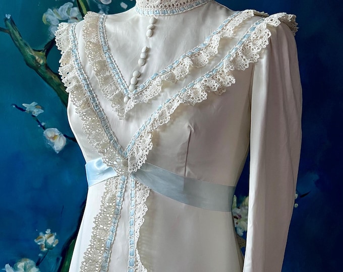 Featured listing image: 1960s 70s Cream Satin Prairie Princess Bride Wedding Dress Antique Vibe Design Crochet Lace Eyelet Trim Blue Silk Ribbon Bow Wedding Gown S