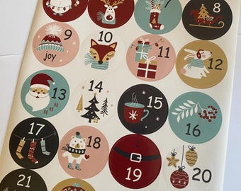 May include: A sheet of twenty-four circular stickers featuring Christmas-themed illustrations and numbers from one to twenty-four. The designs include a penguin, snowman, reindeer, fox, Santa, rabbit, ornaments, stockings, gifts, and festive text.