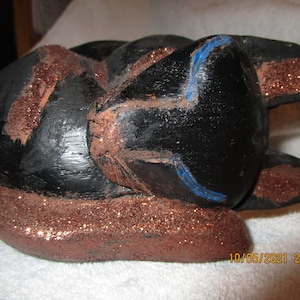 Beautiful carved and handpainted Siamese Cat sleeping.