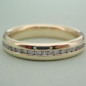 May include: A gold band with a single row of small diamonds set into the metal.