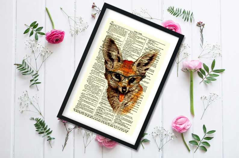 May include: Framed art print featuring a whimsical illustration of a fox wearing glasses, set against a vintage dictionary page background. The fox is depicted in shades of brown and orange, with a red accent on its head.