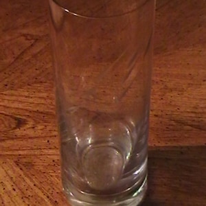 Mid-century heavy footed glass vase with raindrop etchings.