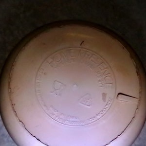 May include: A white round lid with the words "Home Preference" printed on it. The lid has a small crack on the side.