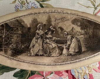 May include: An antique, oval-shaped box with a sepia-toned illustration of a historical scene. The image depicts three women in period clothing, a water mill, and the text "Pierre, 16 January 1903". The box has a cream-colored background.
