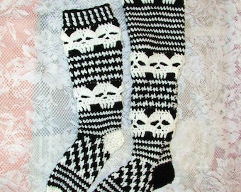 May include: A pair of black and white crocheted knee-high socks with a skull pattern. The socks are made with a white yarn and have a black skull design.