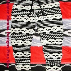 May include: Black and white crocheted pants with a skull pattern. The pants have a drawstring waistband and are made with a thick yarn.