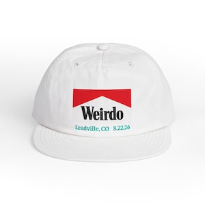 May include: A white baseball cap featuring a graphic on the front panel. The graphic includes a red trapezoid shape above the black text "Weirdo" and the teal text "Leadville, CO 8.22.26" printed below the word "Weirdo" on the white fabric surface.