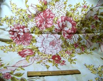 May include: Cream-colored fabric with a large floral pattern featuring pink and red peonies, white daisies, and yellow accents. Green leaves and pink ribbons complement the flowers. A wooden ruler with text is at the bottom.