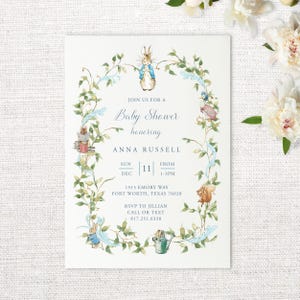 May include: A blue and green baby shower invitation with a watercolor illustration of Peter Rabbit and other woodland creatures. The invitation reads "Join us for a Baby Shower honoring Anna Russell" and includes the date, time, and location of the event. RSVP information is also included.