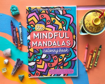 May include: A colorful coloring book titled "The Mindful Mandalas Coloring Book" with 36 mandala coloring pages and mindfulness exercises to help bring calm and awareness into your life. The cover features a vibrant mandala design with a variety of colors and patterns.