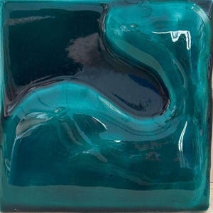 May include: Square ceramic tile with a glossy finish, featuring an abstract design in teal and dark blue. The tile has a raised, wave-like pattern, adding depth and texture. The colours blend and reflect light, creating a sense of movement. The overall aesthetic is modern and artistic.