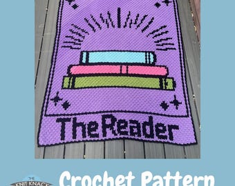 May include: A purple crochet blanket featuring a stack of books in green, pink, and blue, with a sunburst design above. The text "The Reader" is displayed below the books. The words "Crochet Pattern" are also visible.