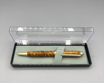 May include: A wooden pen with gold accents in a black and clear plastic box.