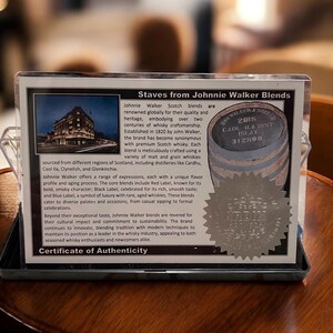 Pu&ograve; includere: Primo piano di un certificato di autenticit&agrave; delle miscele di Scotch Johnnie Walker. Il certificato include testo sulla storia del marchio e un'immagine di un edificio. &Egrave; presente anche una piccola immagine di botte.