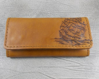 Leather tobacco pouch with pyrography of a ship