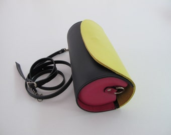 Rounded Leather clutch bag with removable strap. Available in many colors and two sizes