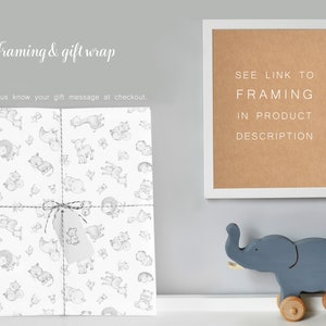 May include: A white gift wrap with a black and white animal print design. The gift wrap is tied with a string and a small tag. The text "SEE LINK TO FRAMING IN PRODUCT DESCRIPTION" is on a brown background in a white frame.