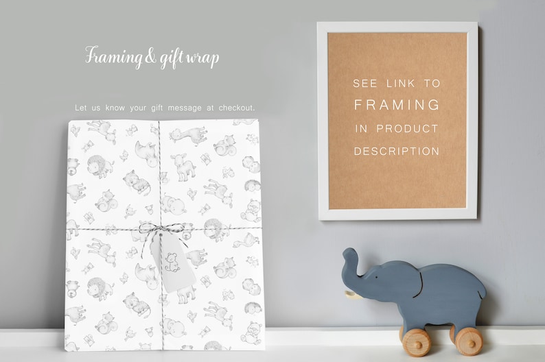 May include: A white gift wrap with a black and white animal print design. The gift wrap is tied with a string and a small tag. The text "SEE LINK TO FRAMING IN PRODUCT DESCRIPTION" is on a brown background in a white frame.