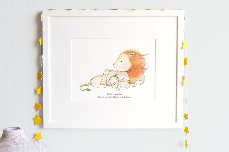 May include: A white frame with a white mat and a print of a lion with two cubs. The print says "Baby Joshua Lots of love from Mummy and Daddy".