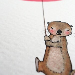 May include: A watercolor illustration of a brown otter holding onto a red string. The otter has a happy expression and is wearing a pink blush on its cheeks.