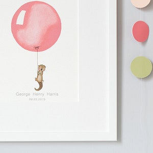 May include: A framed illustration of a brown otter holding onto a pink balloon with the text "George Henry Harris 08.03.2015" below the otter.