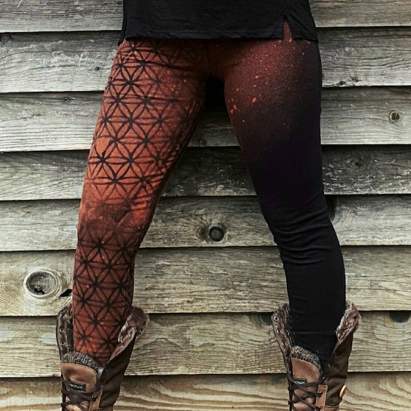 Woman's legging with flower of life on leg, sacred geometry patterns bleached with stencils. Mystical symbols, witches, psytrance festival