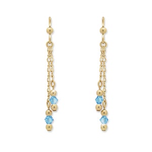 May include: Gold dangle earrings with two blue crystal beads on each earring.