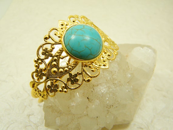gold bracelet with turquoise stone