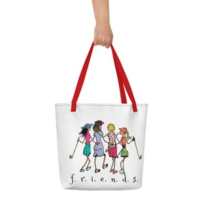 May include: White tote bag with red handles and a cartoon illustration of four women playing golf. The text "f.r.i.e.n.d.s." is printed at the bottom of the bag.
