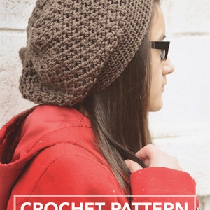 May include: A brown crocheted beanie hat with a textured stitch pattern. The hat is worn by a person with long brown hair and is shown against a white brick wall. The text "CROCHET PATTERN" and "littlemonkeyscrochet" is displayed below the image.