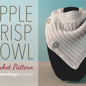 May include: A crocheted cowl in a light beige color with two buttons on the side. The cowl is displayed on a black mannequin. The text "APPLE CRISP COWL Crochet Pattern littlemonkeyscrochet" is displayed on a blue and brown background.