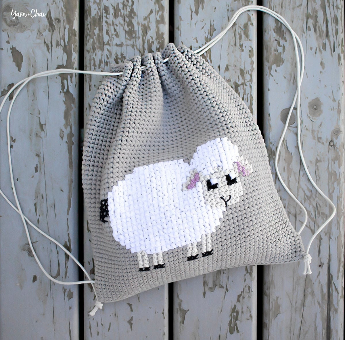 39 Crochet Backpack Patterns with Lambs, Bunnies, and Grannies 1 Pattern: Cross-Stitch Lamb Cinch Backpack (Crochet sheep