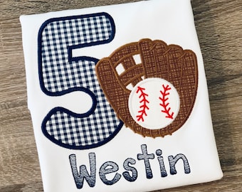 May include: White t-shirt with a blue and white gingham number 5, a brown baseball glove with a white baseball, and the name "Westin" in blue embroidery.