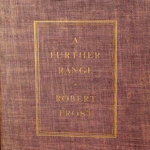 May include: A hardcover book titled "A Further Range" by Robert Frost. The book has a textured, reddish-brown cover with gold lettering and a gold border around the title and author's name. The book is standing upright.
