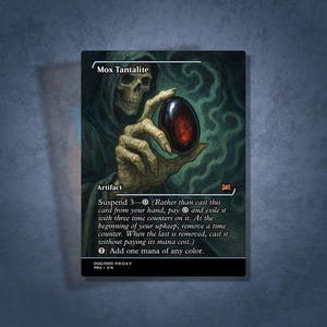 May include: A Mox Tantalite card featuring a skeletal figure holding a dark, oval object. The card has text describing its function as an artifact, with instructions for use. The background is a dark, smoky green.