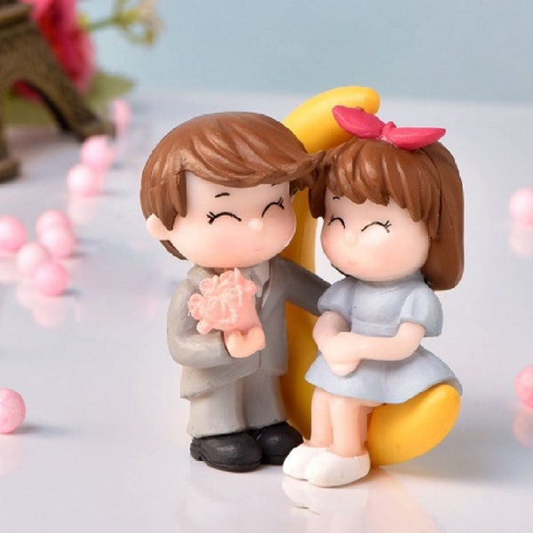 Couple on Moon Miniature Figurines with a Girl and Boy with pink flowers, Made of Resin, Add to dioramas, terriariums, or ornaments