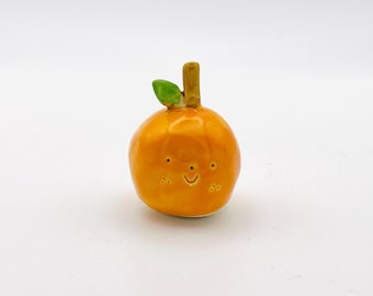 happy orange ceramic ornament