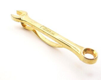 Prendedor de gravata vintage Snap On Tools em tom dourado, acessório formal masculino.