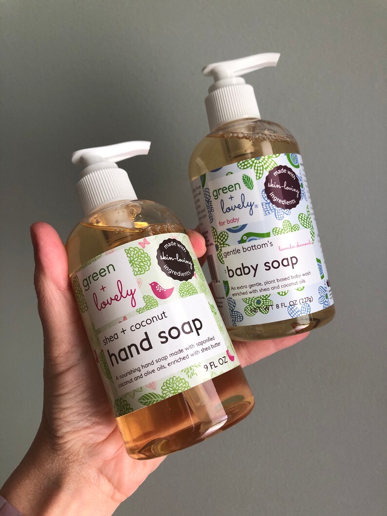 May include: Two clear plastic bottles of Green + Lovely hand and baby soap. The hand soap is shea and coconut scented, 266 ml. The baby soap is 237 ml. Both bottles have white pump dispensers and labels with green floral designs.