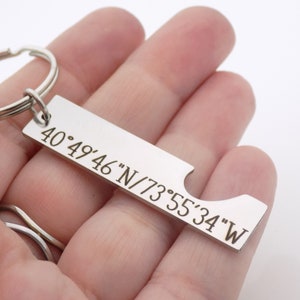 May include: Silver keychain with a bottle opener and engraved coordinates: 40&deg;49'46"N/73&deg;55'34"W.