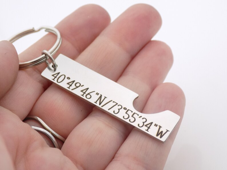 May include: Silver keychain with a bottle opener and engraved coordinates: 40&deg;49'46"N/73&deg;55'34"W.