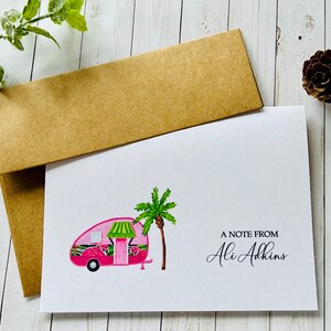 May include: A white card with a pink camper van illustration, a green palm tree, and the text "A note from Ali Adkins".