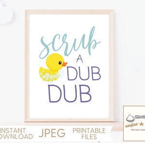 May include: A printable sign with a yellow rubber duck in a bathtub with bubbles. The sign says "Scrub a Dub Dub" in purple and blue lettering.