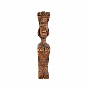May include: A wooden carved statue of a person with a crown on their head. The statue is brown and has a detailed face.