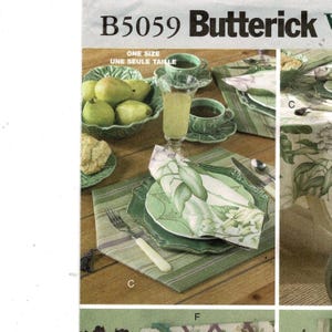 May include: A still-life image featuring a table setting with green-toned tableware. The scene includes a bowl of pears, teacups, a tall glass, and a plate with a floral napkin. The text "B5059 Butterick" and "ONE SIZE UNE SEULE TAILLE" are visible.