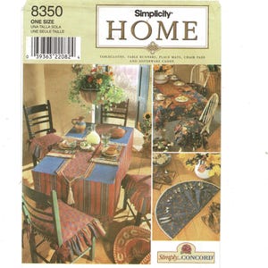 May include: Simplicity Home pattern featuring tablecloths, table runners, place mats, and chair pads. The image shows a dining table set with a red and blue striped tablecloth, matching chair pads, and a table runner with a tassel.