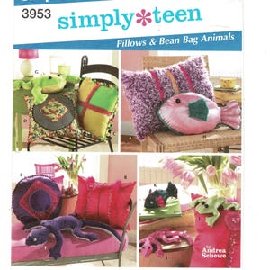 May include: A variety of pillows and bean bag animals are displayed. The image includes a frog, fish, and lizard-shaped bean bags, along with decorative pillows in various colors and patterns. The text "simply teen" and "Pillows & Bean Bag Animals" is visible.