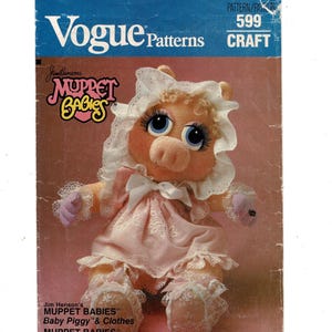 May include: A vintage Vogue Patterns craft pattern featuring Miss Piggy from Jim Henson's Muppet Babies. The pattern cover shows a plush Miss Piggy doll in a pink dress and bonnet. The text includes "Muppet Babies" and "Craft".