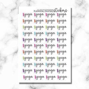May include: Sheet of stickers with the word "yoga" in a cursive font, each accompanied by a colorful silhouette of a person in a yoga pose. The stickers are in various colors, including pink, orange, green, blue, purple, and black.